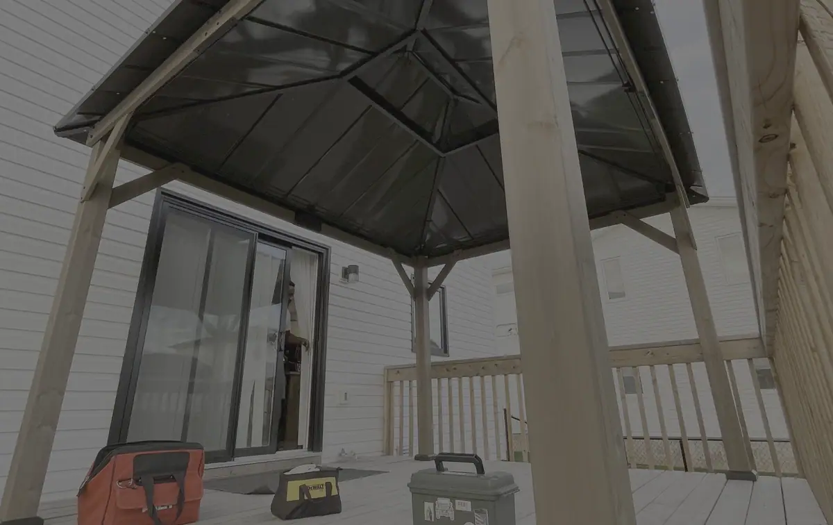 Completed wood and metal gazebo assembled on a backyard deck