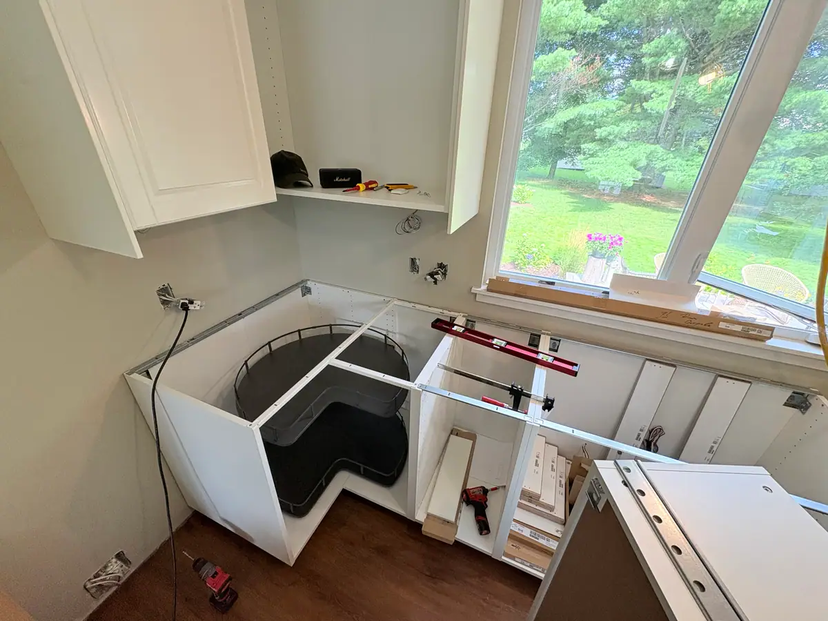 White IKEA kitchen cabinets during installation in a Moncton home